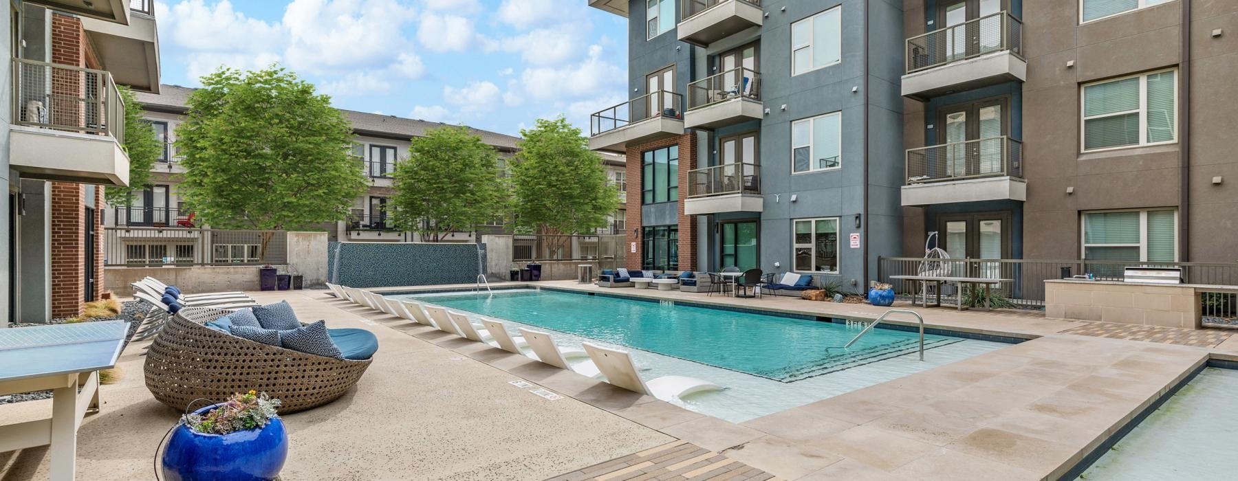 a pool in a courtyard between buildings