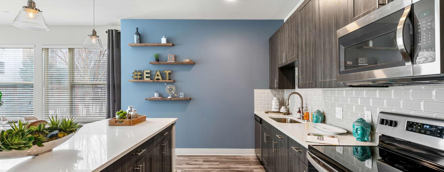a kitchen with a stove and shelves