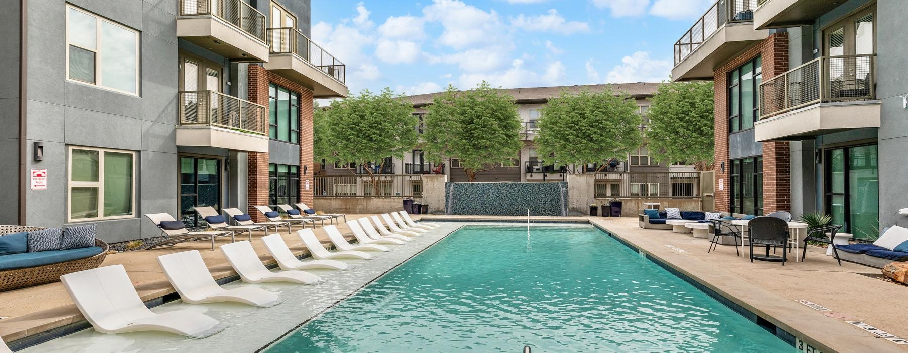 a swimming pool in a courtyard between buildings