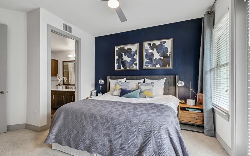 a bedroom with a bed and a fan